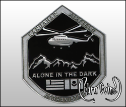 Custom shaped Kandahar Installation coin with a helicopter. Alone in the dark is written under mountains. The US and Afghanistan flags also appear. Kandahar Airfield.